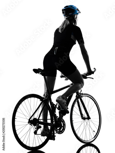 Fototapeta Naklejka Na Ścianę i Meble -  one caucasian cyclist woman cycling riding bicycle in silhouette isolated on white background rear view