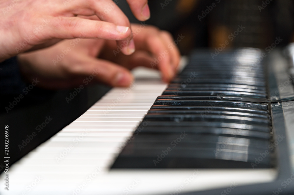 Hands of a pianist close-up. Plays on the synthesizer