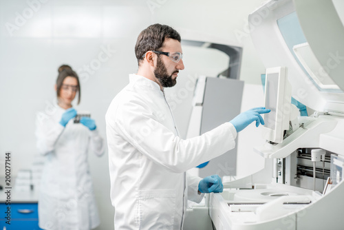 Laboratory assistants working with analizer