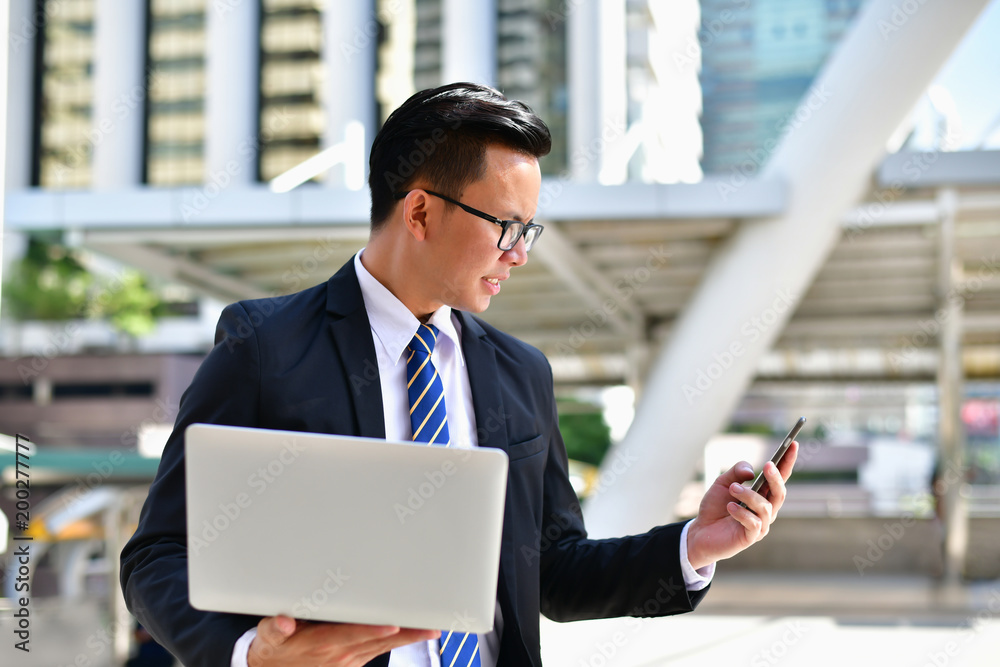Business Concept Communication, Young businessman is playing mobile. Business Concept Communication, Young businessman is playing mobile.