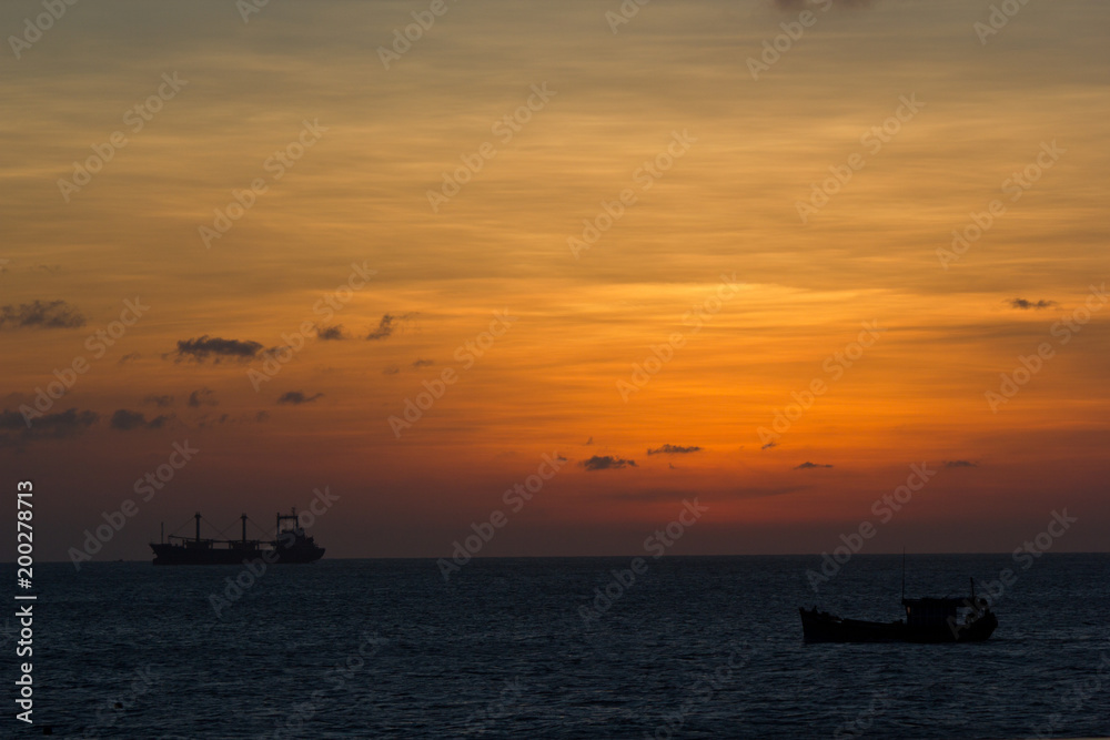 Sunset over the sea and a big ship
