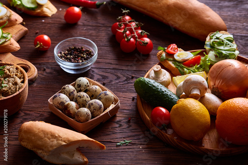 Breakfast still life with sandwiches, quail eggs, spicies and fresh fruits and vegetables, selective focus photo