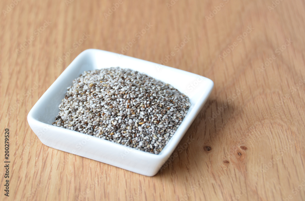 Organic Dry Chia Seeds in small white plate Organic Dry Chia Seeds in small white plate