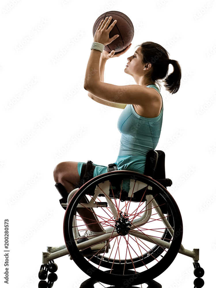 Fototapeta premium one caucasian young handicapped basket ball player woman in wheelchair sport tudio in silhouette isolated on white background