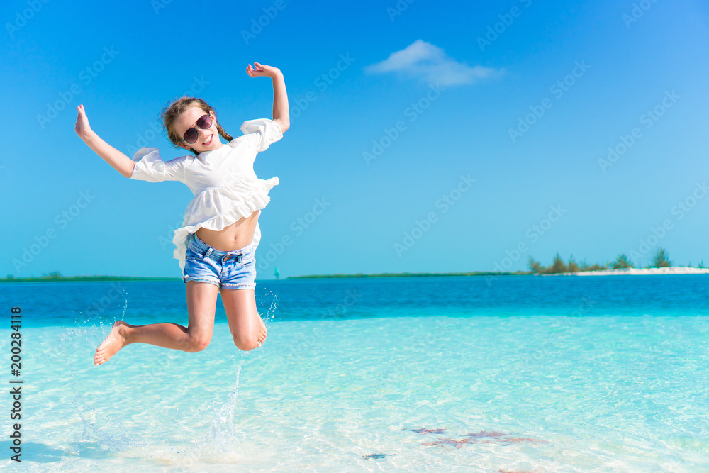 Adorable little girl having fun on the beach full of starfish on the sand Adorable little girl having fun on the beach full of starfish on the sand