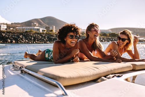 Women friends relaxing on a private yacht deck © Jacob Lund