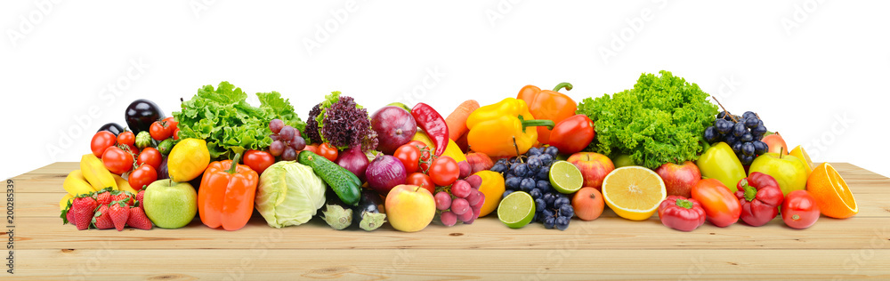 Vegetables and fruits on wooden table boards isolated on white Vegetables and fruits on wooden table boards isolated on white