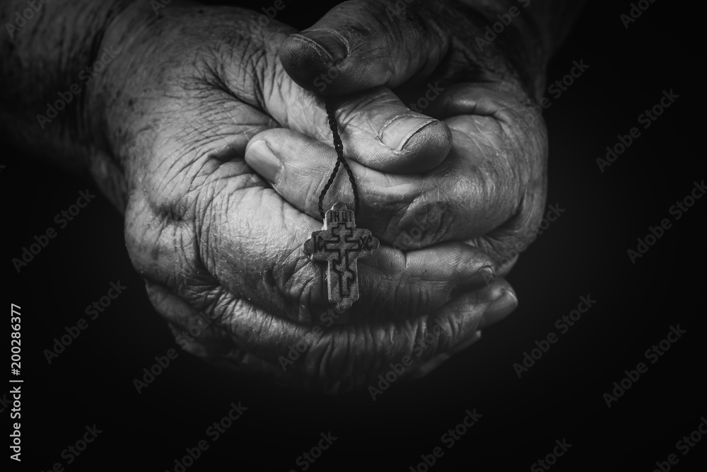 The cross is in the hands of the old man. The cross is in the hands of the old man.