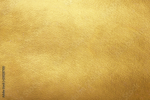 Gold background. Rough golden texture. Luxurious gold paper template for text design, lettering.