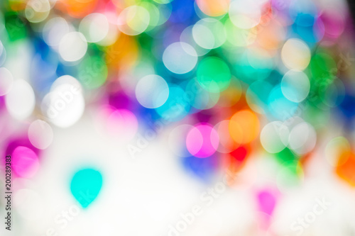 Abstract background with bright multicolor defocused lights.