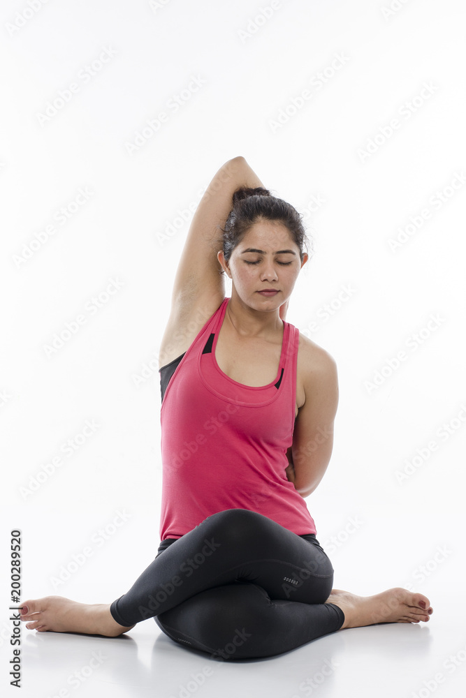  Young woman doing yoga, India
