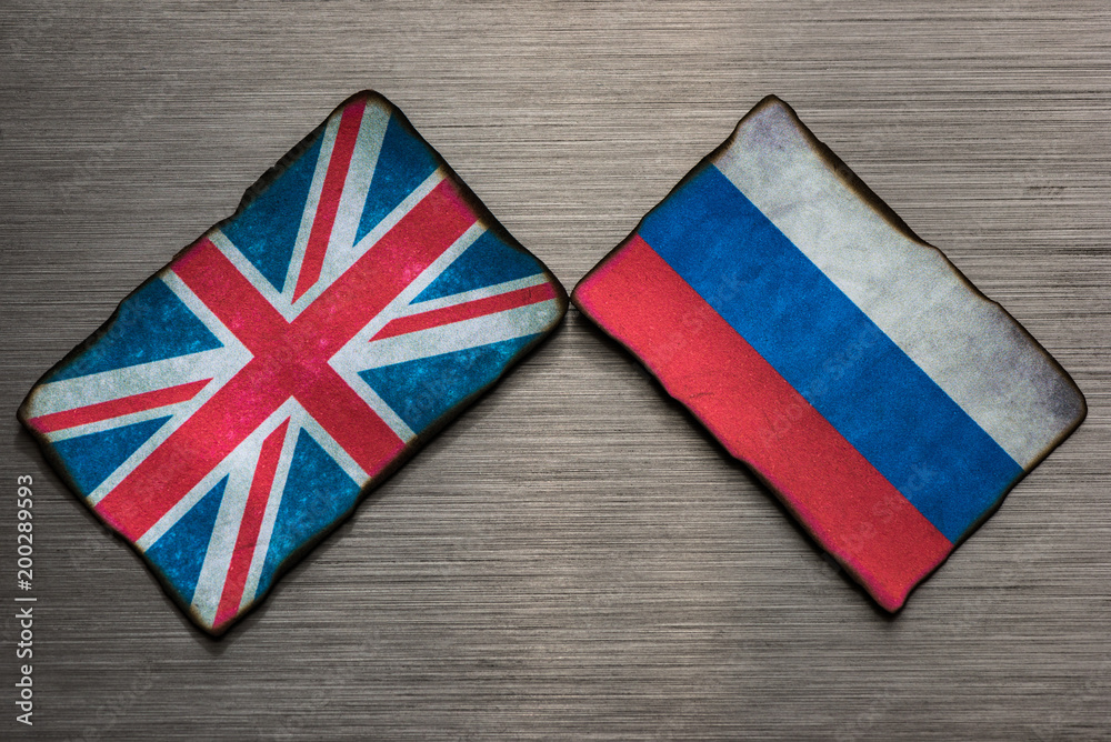 Obraz premium Flags of the United Kingdom and Russia side by side on dark grey brushed metal background