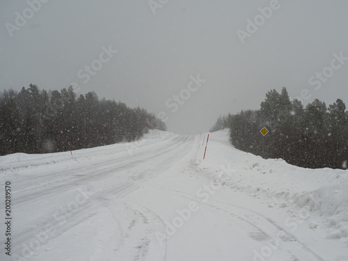 Road passing through snow covered landscape, Arjeplog, Norrbotten County, Lapland, Sweden photo