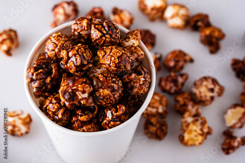Sweet golden caramel flavoured popcorn in a a glass.