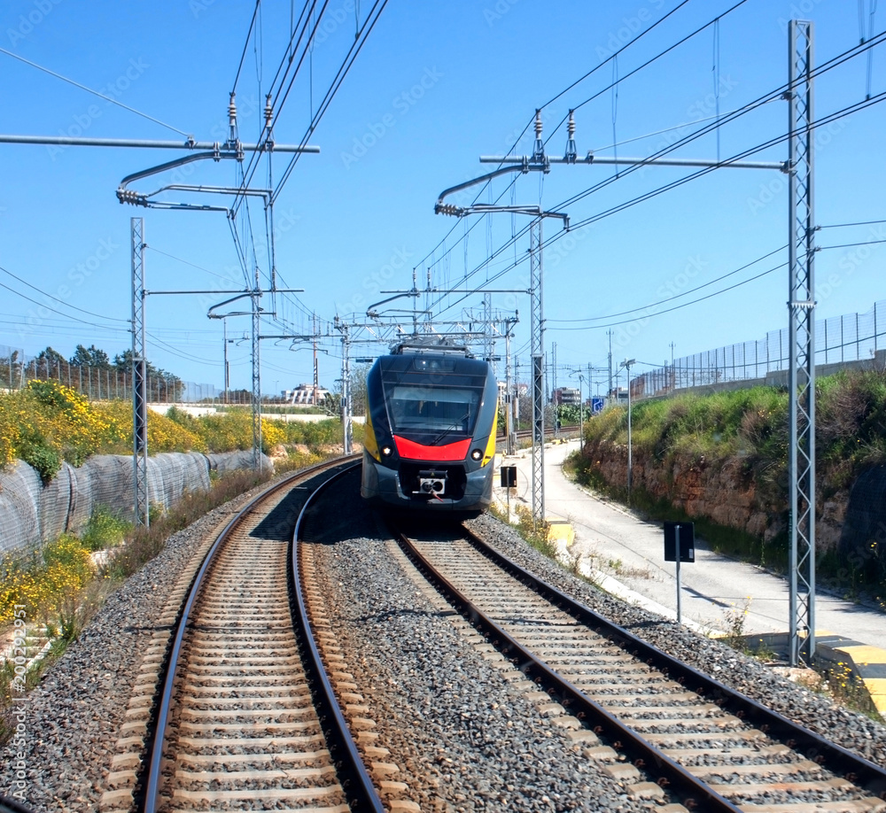 The train moving along the rails in summer time