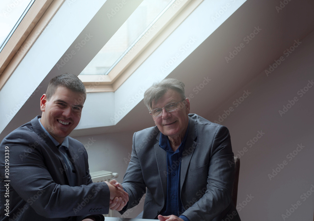 Satisfied executive congratulating new employee. Satisfied executive congratulating new employee.