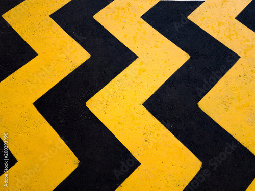 A yellow stripe speed ramp on concrete road. © Alis