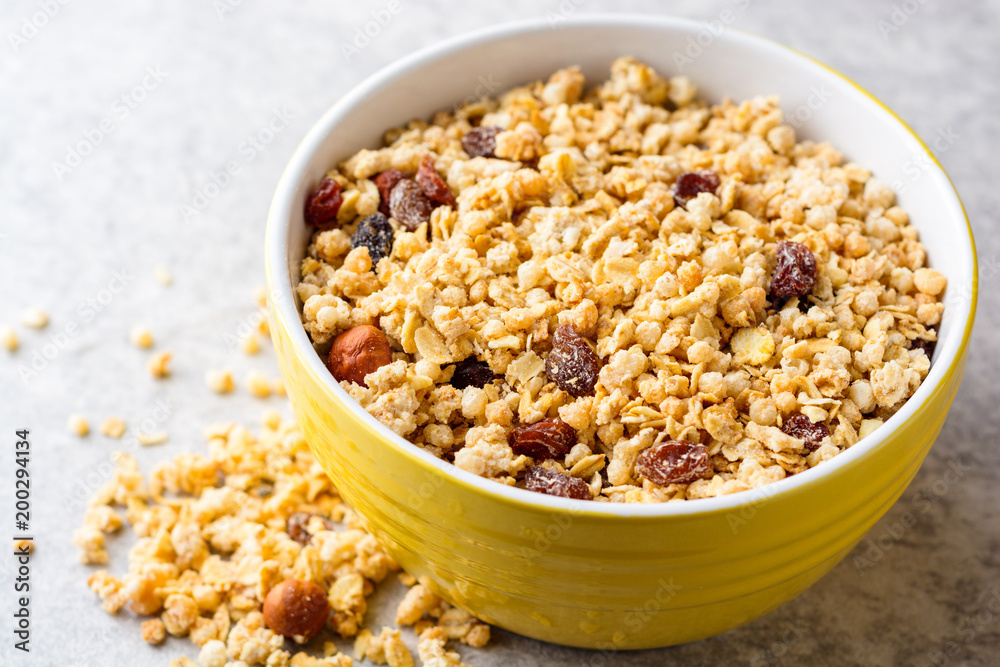 Granola and muesli in bowl on gray stone background Granola and muesli in bowl on gray stone background