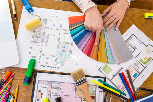 Designer hands choosing colour on swatch, close up