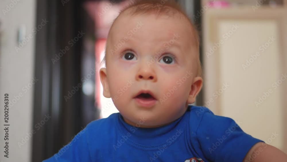 Cute 6 months baby lying down on a carpet at children room Cute 6 months baby lying down on a carpet at children room