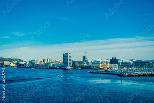 Beautiful landscape view of huge buildings with snowy mountains peeking out behind Bodo city