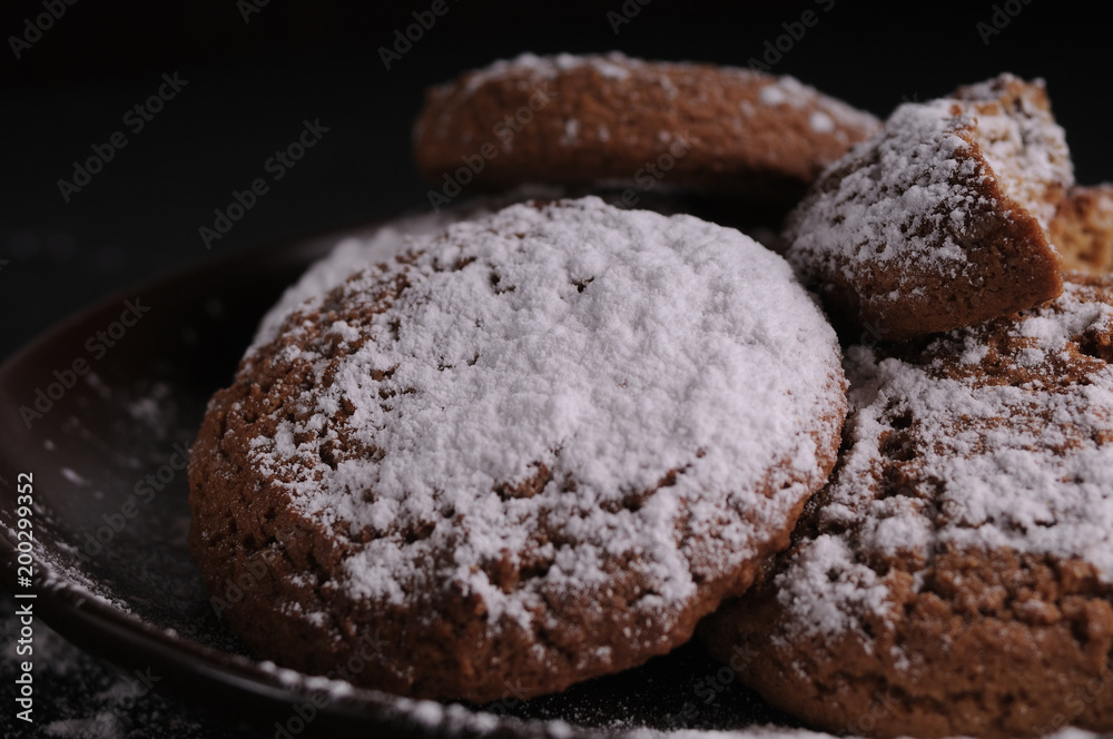 oatmeal cookies on a black table in castor sugar oatmeal cookies on a black table in castor sugar