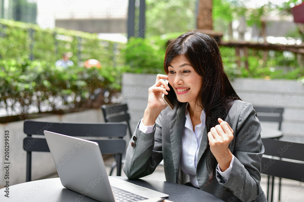 Business Concept.Young Asian businesswoman is working happily.Young businesswoman working in a cafe.Young businesswoman is relaxation in a coffee shop. Business Concept.Young Asian businesswoman is working happily.Young businesswoman working in a cafe.Young businesswoman is relaxation in a coffee shop.