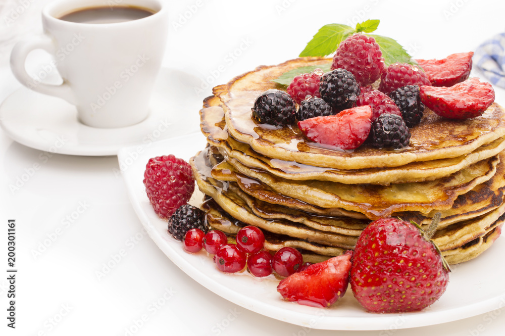 Delicious pancakes with berries and maple syrup on a white background Delicious pancakes with berries and maple syrup on a white background