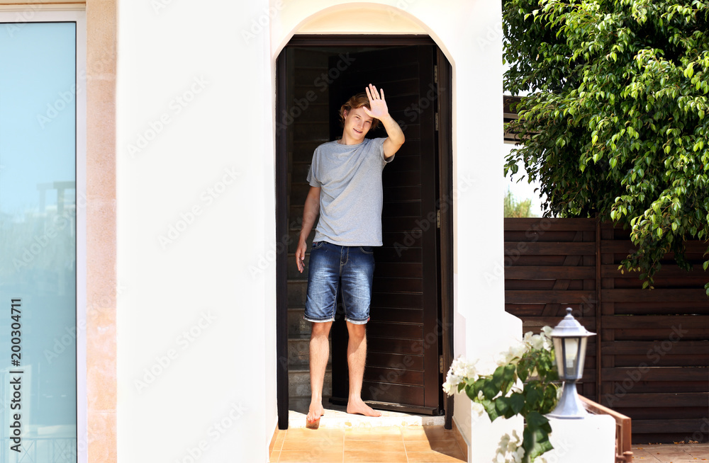 Man opening the door of her home.Inviting the guests Man opening the door of her home.Inviting the guests