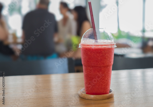 Fresh watermelon smoothie on wooden table in coffee shop
