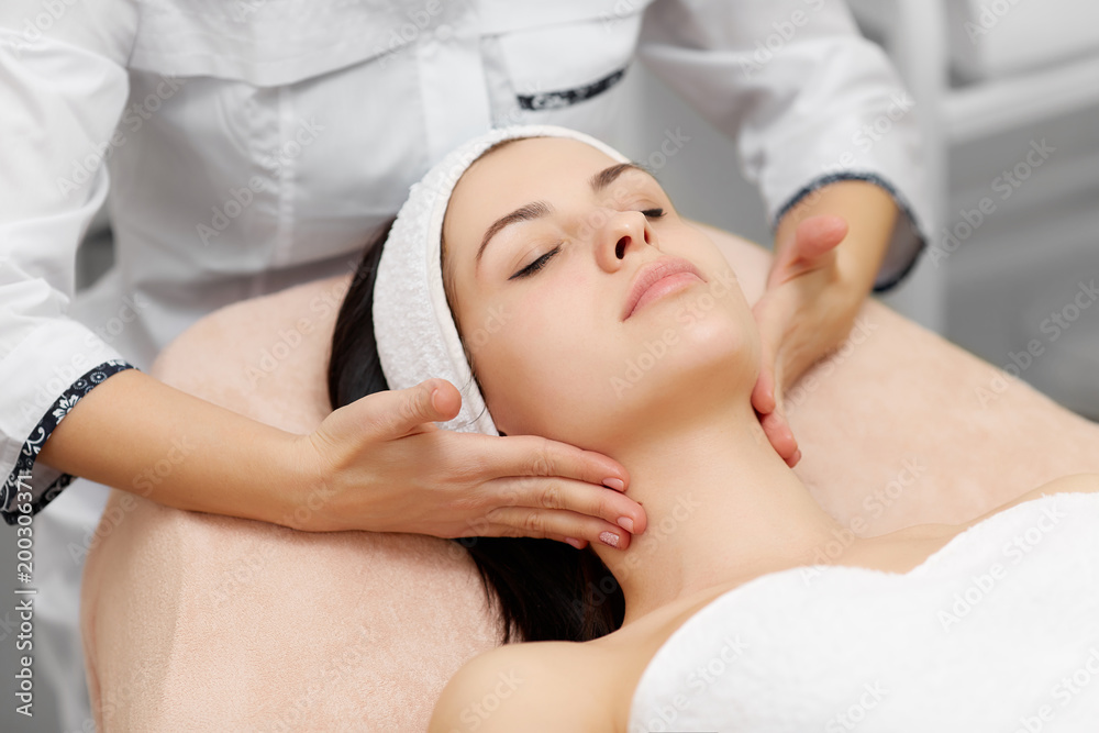 Attractive woman enjoying moisturizing procedures in beauty salon.