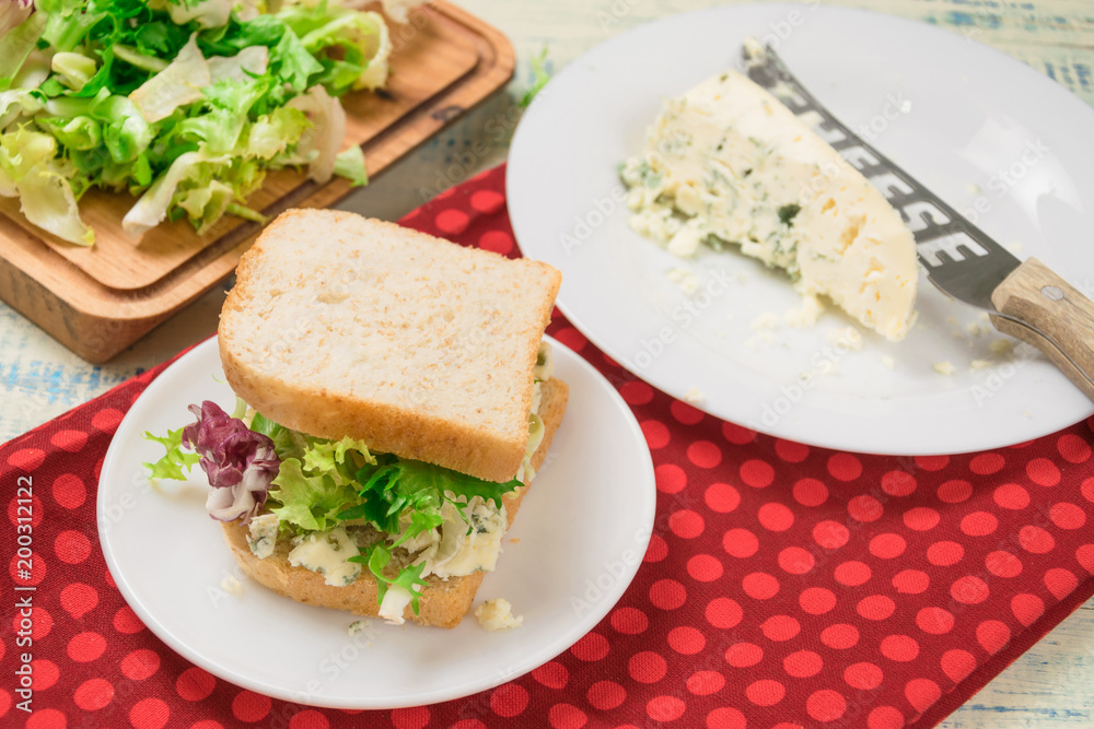 Vegetarian sandwich with salad and blue cheese on a wooden background. Healthy Diet