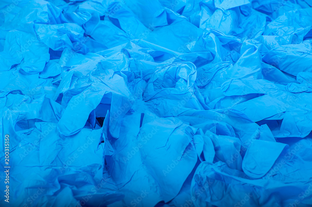 A lot of blue latex medical rubber gloves