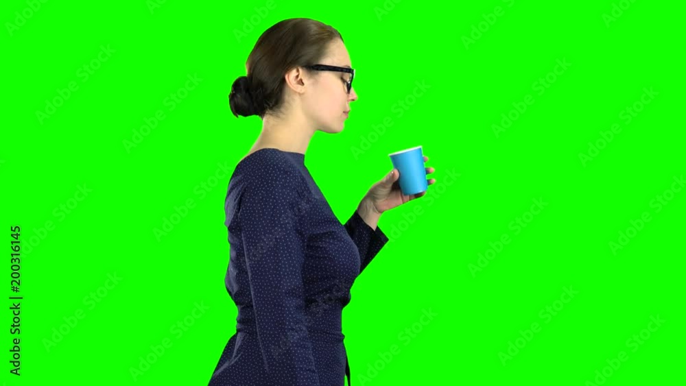 Teacher goes and drinks water from the glass. Green screen Teacher goes and drinks water from the glass. Green screen
