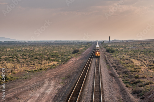 Straight on View of Train Rolling Aross Desert