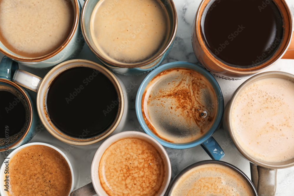 Many cups of different aromatic hot coffee on table, top view Many cups of different aromatic hot coffee on table, top view