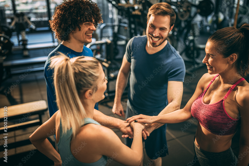 Group of young people in the gym. Having fun. Making a deal for best  workout. Stock Photo
