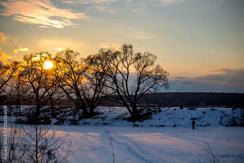 Beautiful sunset on a winter evening over the river in February
Beautiful sunset on a winter evening over the river in February