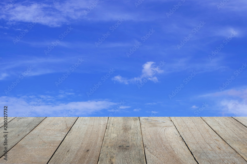 Old wooden foreground with blue sky and clouds background, copy space Old wooden foreground with blue sky and clouds background, copy space