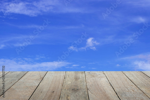 Old wooden foreground with blue sky and clouds background, copy space