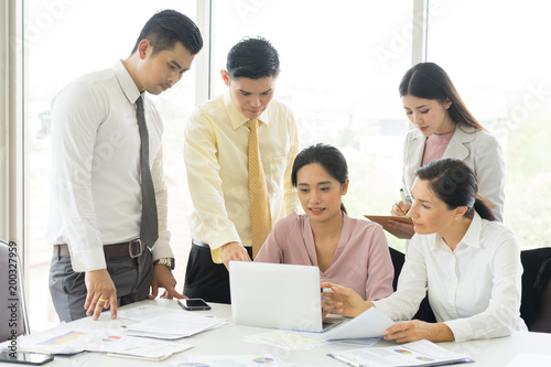 Happy business people cheering and showing thumb up at office. Happy time in the office.