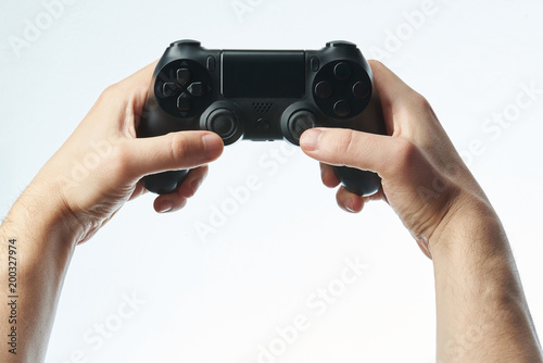 Hands holding black game controller