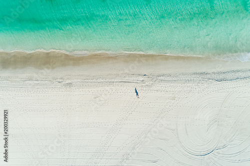 aerial views of summer beach scene with coastline turquoise waters and white sandy beach
