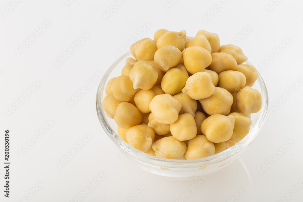 Chickpea grains (Cicer arietinum) in bowl isolated on white background Chickpea grains (Cicer arietinum) in bowl isolated on white background