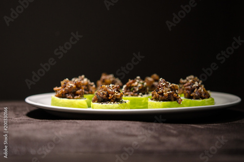 Sushi rolls in white plate and dark background