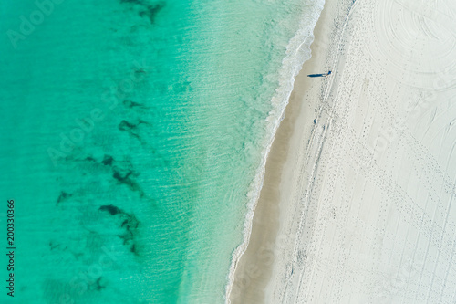 aerial views of summer beach scene with coastline turquoise waters and white sandy beach