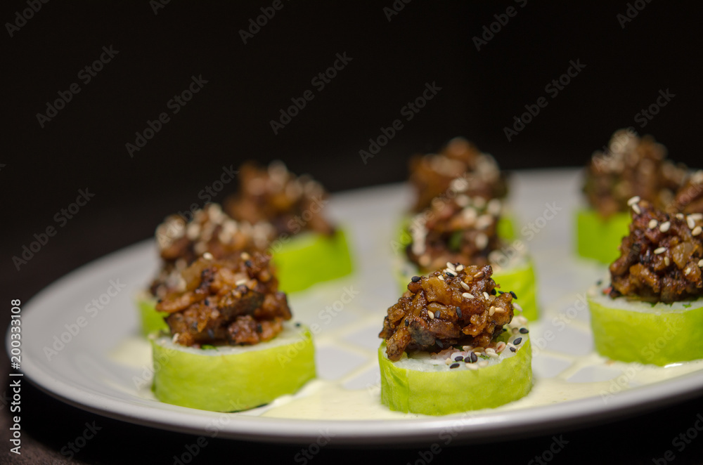 Sushi rolls in white plate and dark background Sushi rolls in white plate and dark background