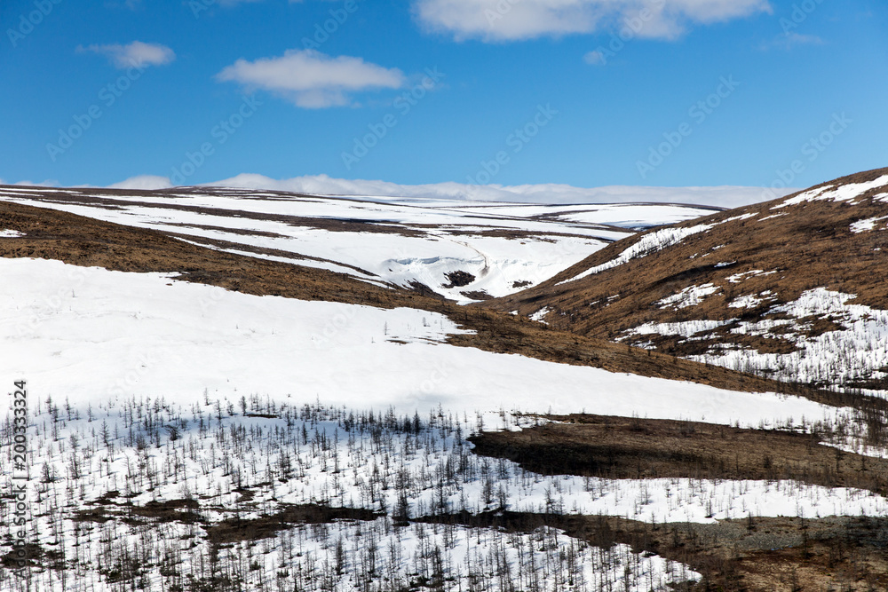 Northern landscape. The mountains are covered with glaciers. View from helicopter flight altitude Northern landscape. The mountains are covered with glaciers. View from helicopter flight altitude