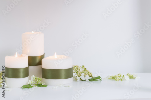 candles and flowers on white background