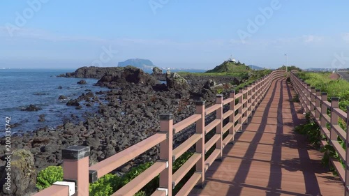 Jongdalri coast trail and Observatory in Jeju island, Korea. The trail is famous for beautiful scenery. The observation platform is made of an old ship and you can see Udo island there. photo